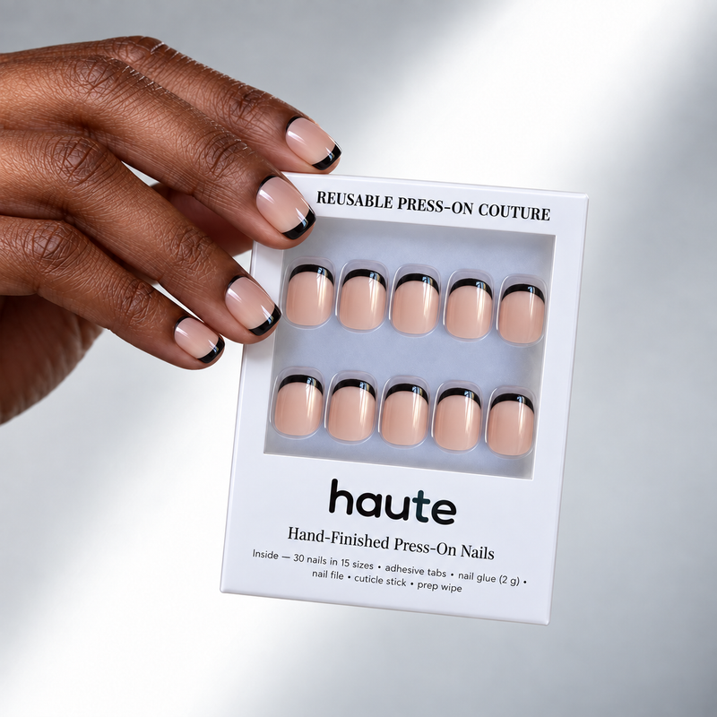 black tie super short square black French tip press-on nails worn while holding the haute box