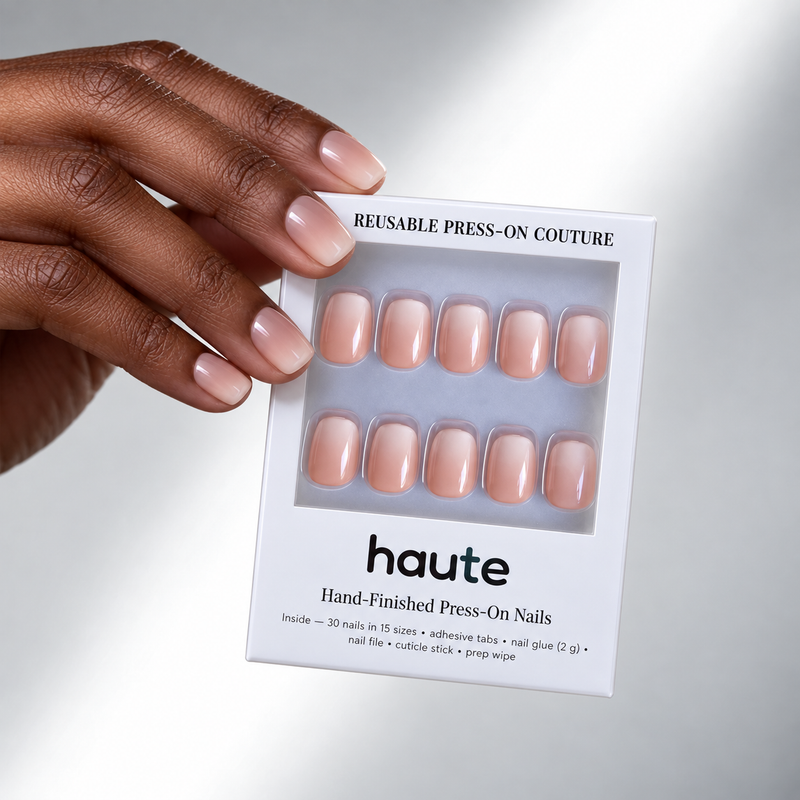 caught blushing super short square baby-pink nude press-on nails worn while holding the haute box
