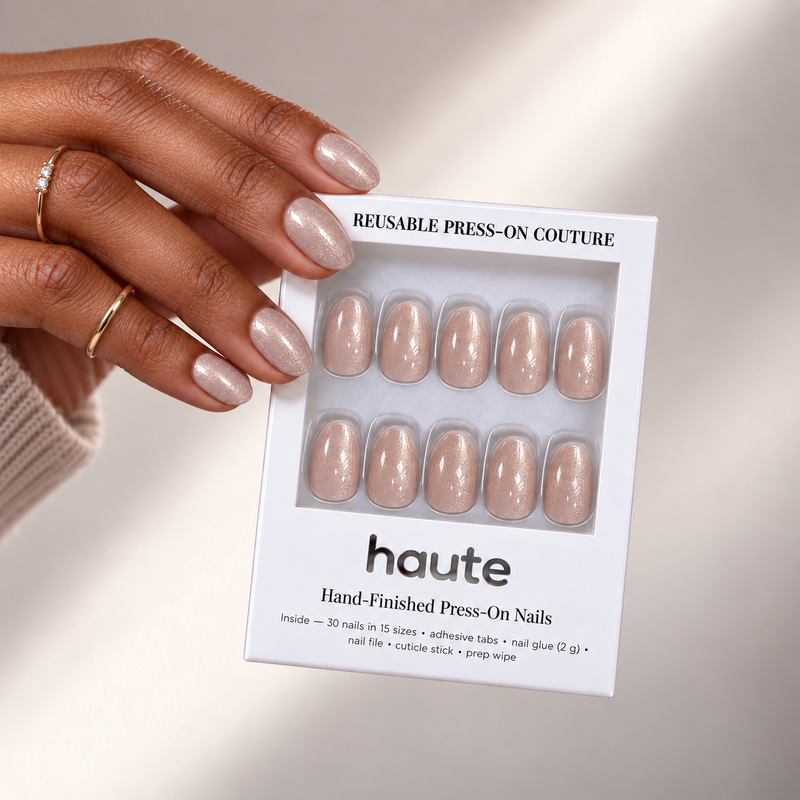 champagne hush short oval champagne shimmer press-on nails worn while holding the haute box