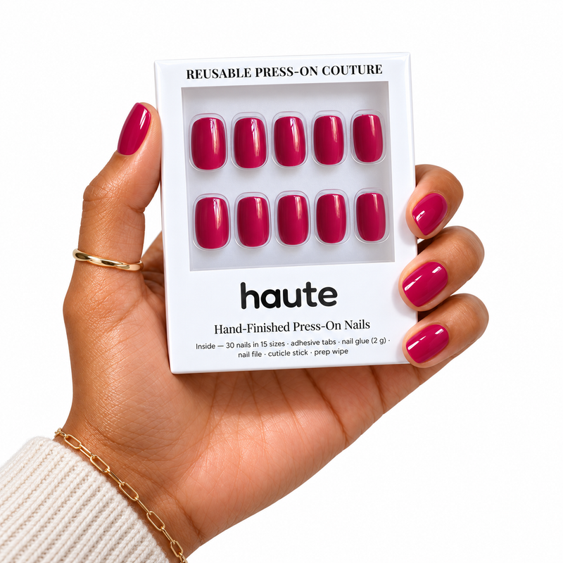 cherry secret short square raspberry red press-on nails worn while holding the haute box