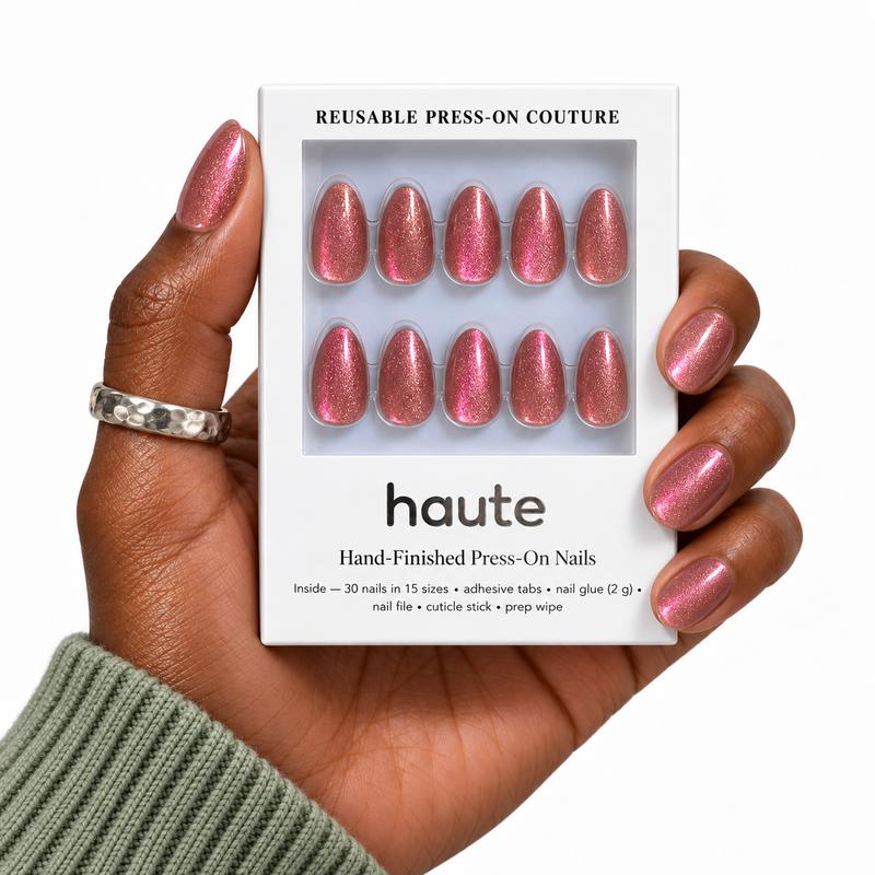 pink afterparty short oval rosy pink cat-eye press-on nails worn while holding the haute box