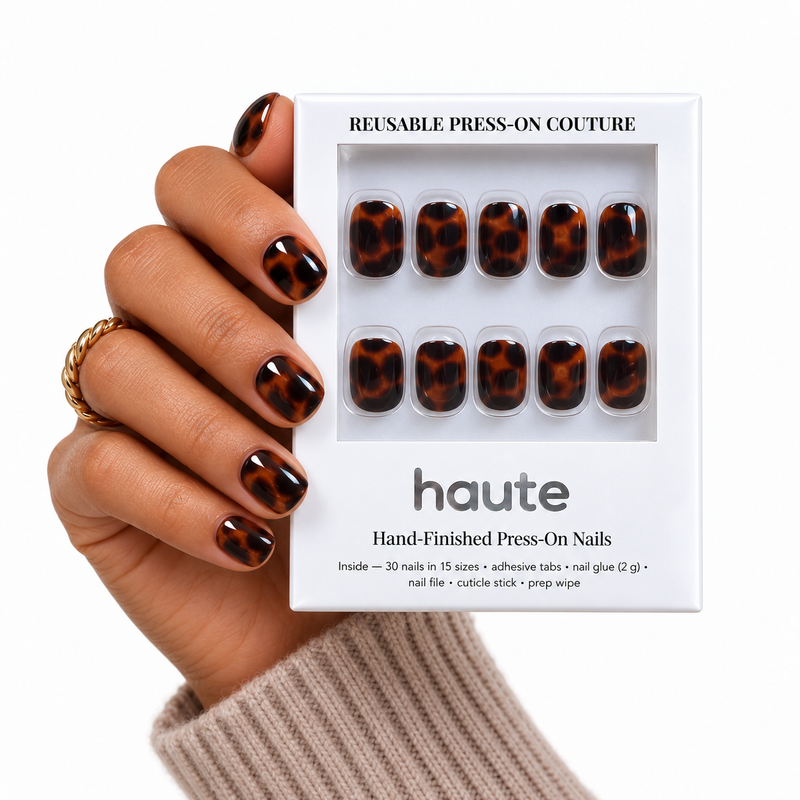 shell crush super short square tortoiseshell press-on nails worn while holding the haute box