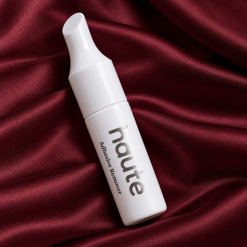 the reset nail glue remover bottle on burgundy satin