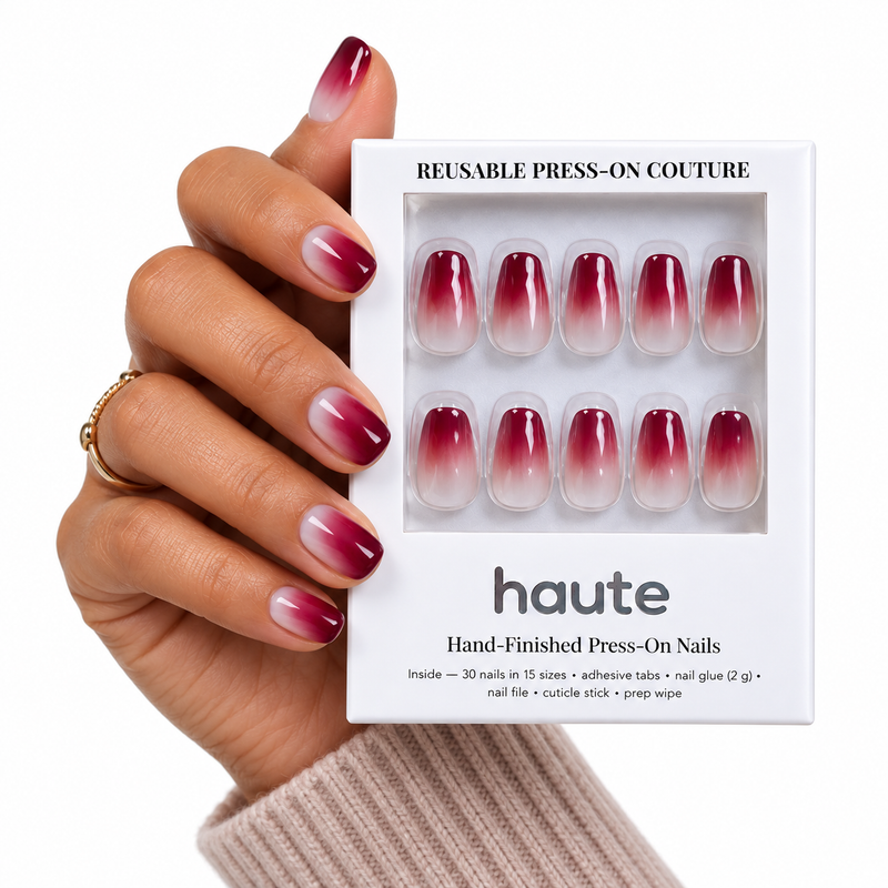 cherry on mute short coffin cherry red ombre press-on nails worn while holding the haute box