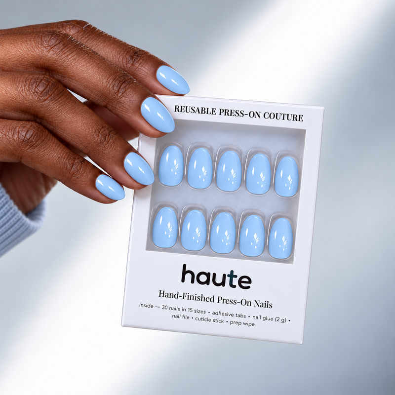 cloud nine-ish super short almond powder blue press-on nails worn while holding the haute box