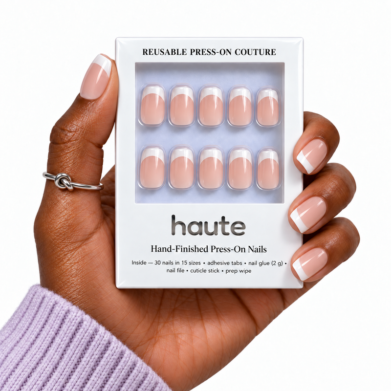 french benefits short square French press-on nails worn while holding the haute box