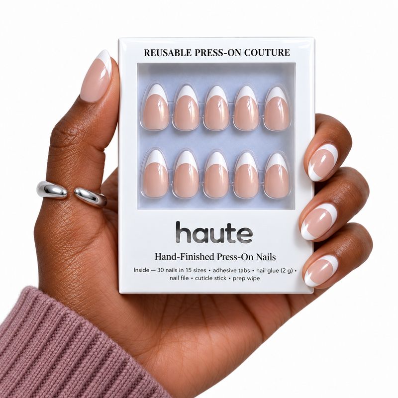 oui bebe short almond French press-on nails worn while holding the haute box