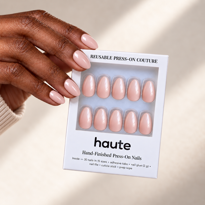 peach affair short almond sheer peachy nude press-on nails worn while holding the haute box