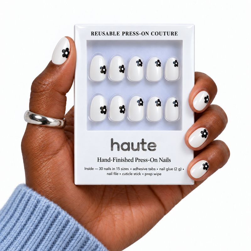 petal party super short oval floral press-on nails worn while holding the haute box