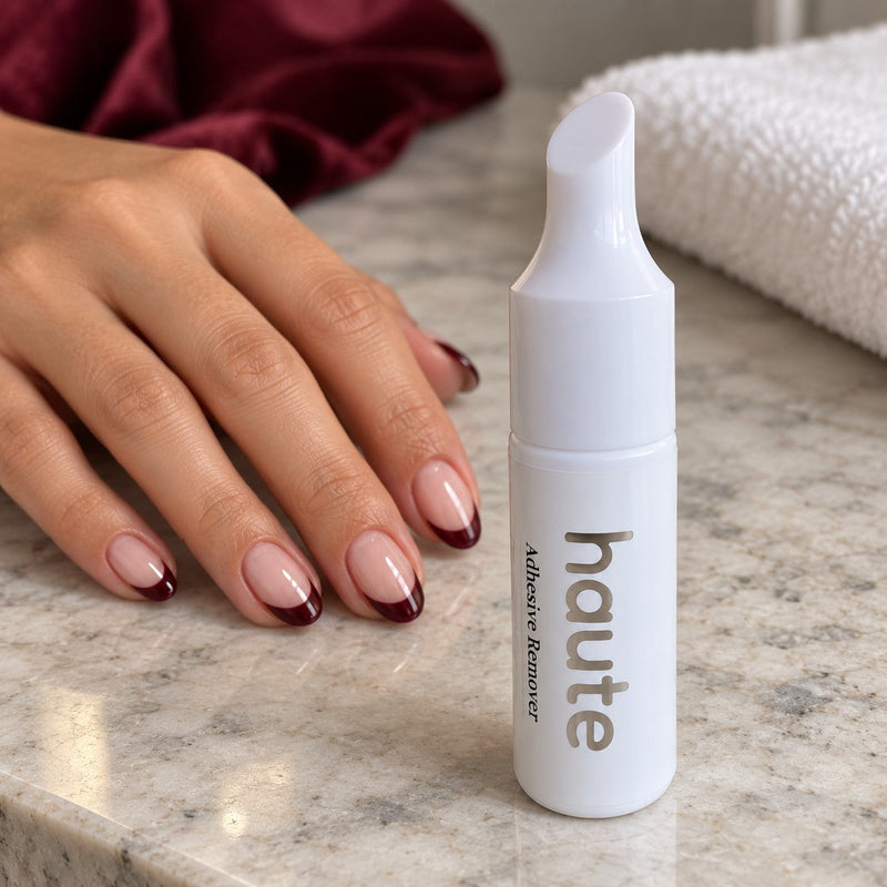 the reset nail glue remover beside a hand wearing haute press-on nails