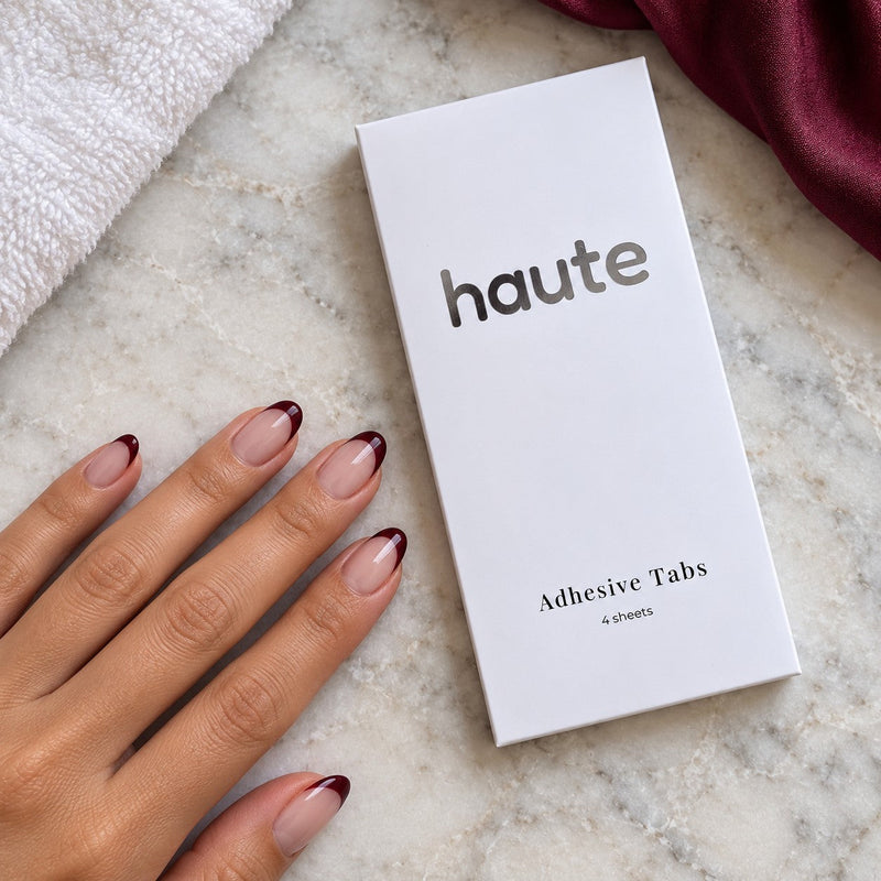 the switch adhesive tabs beside a hand wearing haute press-on nails